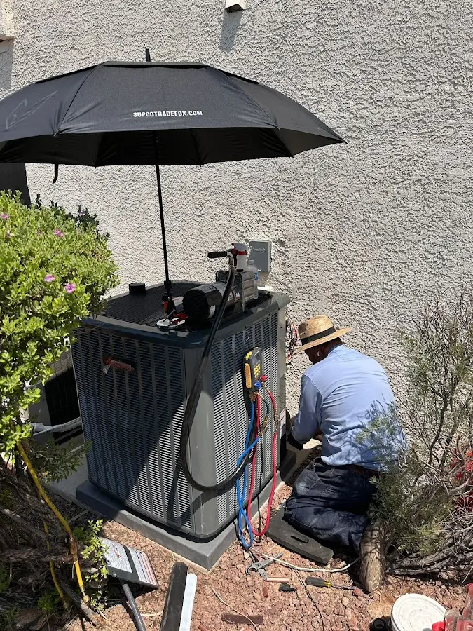 HVAC technician performing outdoor AC maintenance in Fitzgerald